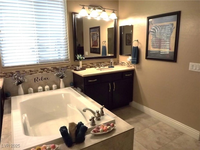 4242 Helena Hideaway Ct, Las Vegas, NV 89129 - bathroom with a garden tub, baseboards, vanity, and tile patterned floors
