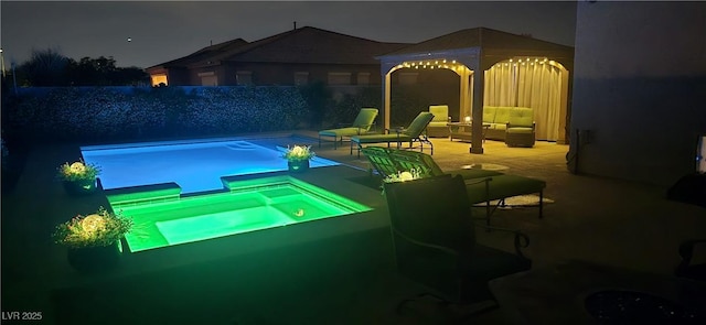 4242 Helena Hideaway Ct, Las Vegas, NV 89129 - pool at night featuring a gazebo, an in-ground hot tub, and a patio area