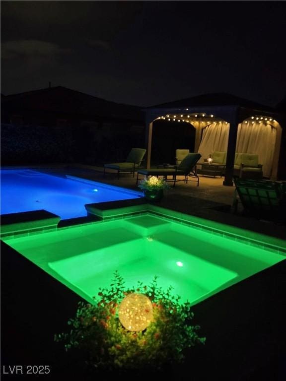 4242 Helena Hideaway Ct, Las Vegas, NV 89129 - pool at twilight with a patio and a pool with connected hot tub