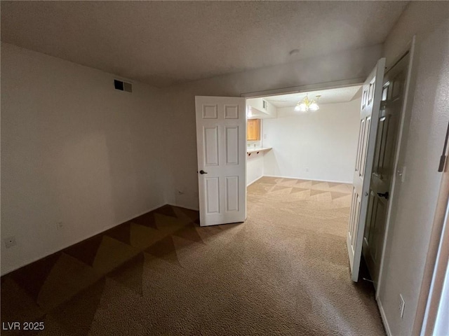 8940 Antioch Way, Las Vegas, NV 89117 - unfurnished room featuring carpet, a chandelier, and a textured ceiling