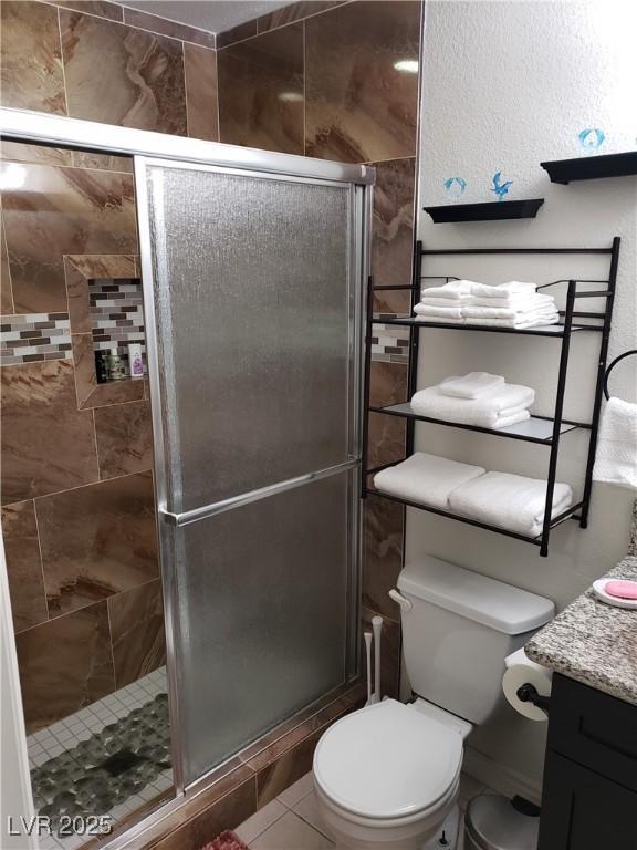 266 Lyra Ln, Las Vegas, NV 89110 - full bath with vanity, toilet, a stall shower, and tile patterned flooring