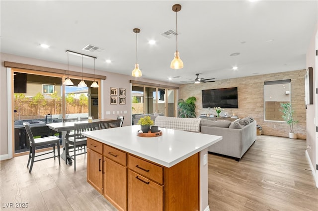 12430 Foxtail Run Ave, Las Vegas, NV 89138 - kitchen featuring a center island, a ceiling fan, light wood finished floors, hanging light fixtures, and recessed lighting