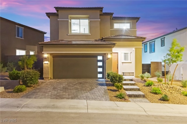 12430 Foxtail Run Ave, Las Vegas, NV 89138 - view of front of house featuring stucco siding, a garage, and decorative driveway