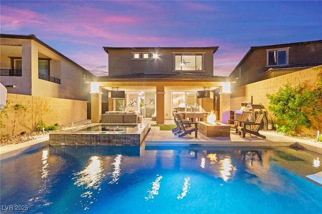 12430 Foxtail Run Ave, Las Vegas, NV 89138 - back of property featuring an outdoor living space with a fire pit, a fenced backyard, stucco siding, a patio area, and a pool with connected hot tub