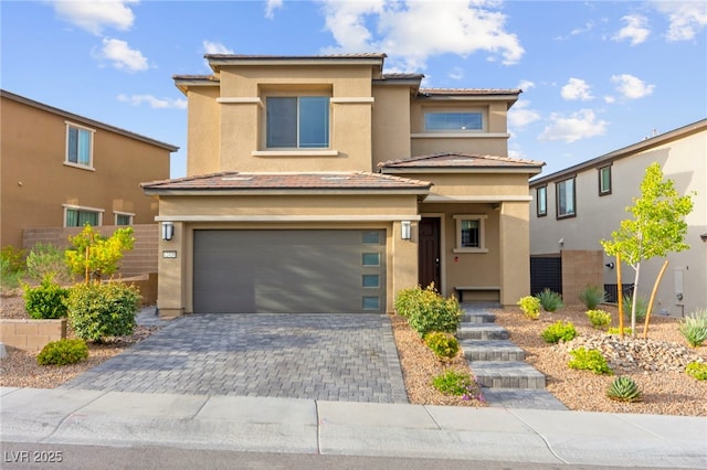 12430 Foxtail Run Ave, Las Vegas, NV 89138 - view of front of home with an attached garage, stucco siding, decorative driveway, and a tile roof