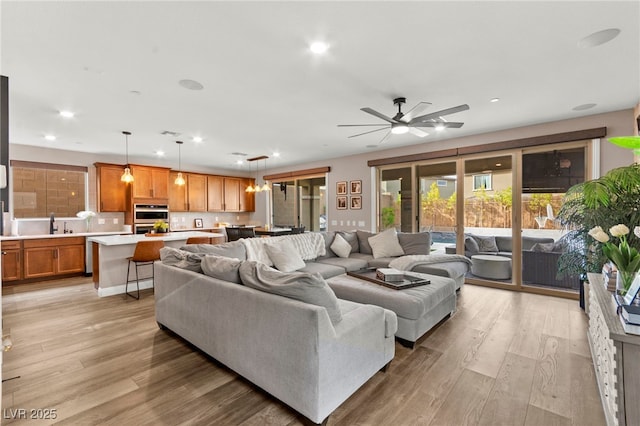 12430 Foxtail Run Ave, Las Vegas, NV 89138 - living area featuring light wood finished floors, recessed lighting, and a ceiling fan
