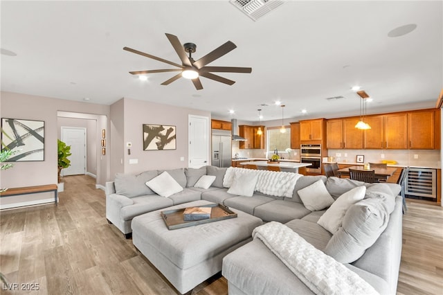 12430 Foxtail Run Ave, Las Vegas, NV 89138 - living room featuring wine cooler, a ceiling fan, light wood finished floors, recessed lighting, and baseboards