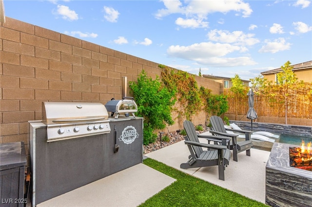 12430 Foxtail Run Ave, Las Vegas, NV 89138 - fenced backyard with area for grilling, a fire pit, and a patio area