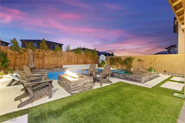 12430 Foxtail Run Ave, Las Vegas, NV 89138 - yard at dusk with a fire pit and a patio