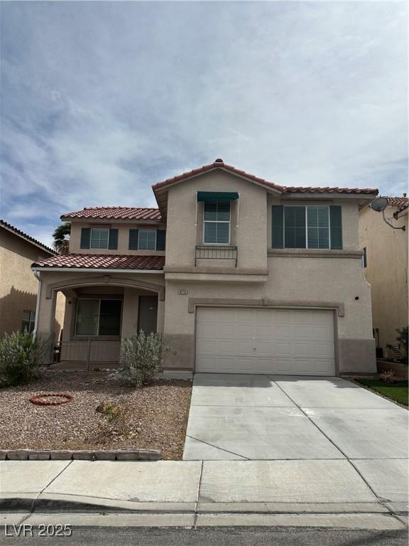 8215 Shell Beach Ct, Las Vegas, NV 89117 - view of front of property featuring a tiled roof, an attached garage, stucco siding, and driveway