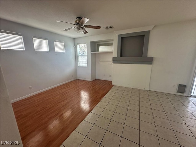 8215 Shell Beach Ct, Las Vegas, NV 89117 - empty room featuring a ceiling fan, light wood-style floors, baseboards, and built in shelves