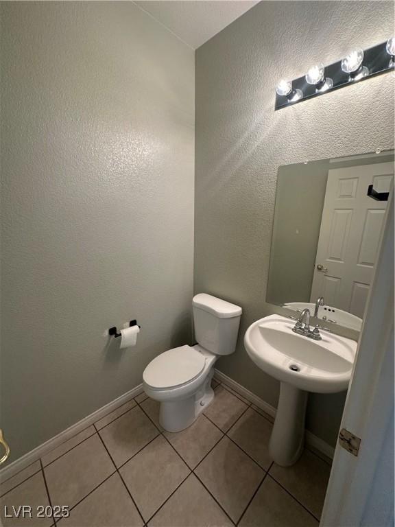 8215 Shell Beach Ct, Las Vegas, NV 89117 - bathroom with tile patterned floors, toilet, and baseboards