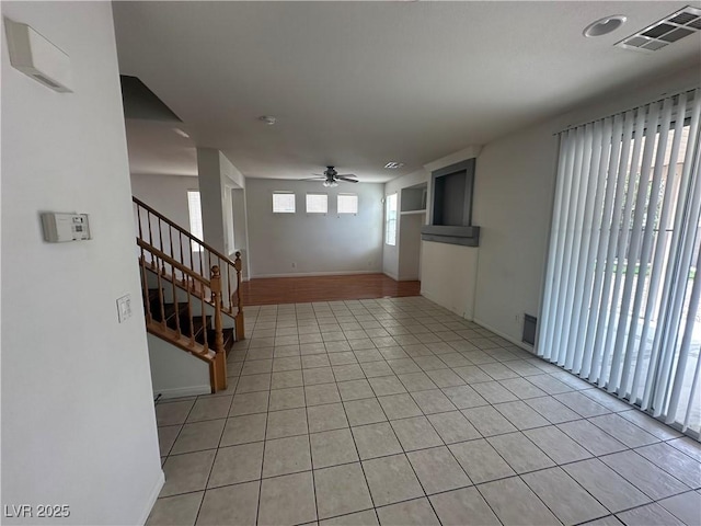 8215 Shell Beach Ct, Las Vegas, NV 89117 - empty room with ceiling fan, stairway, light tile patterned flooring, and baseboards