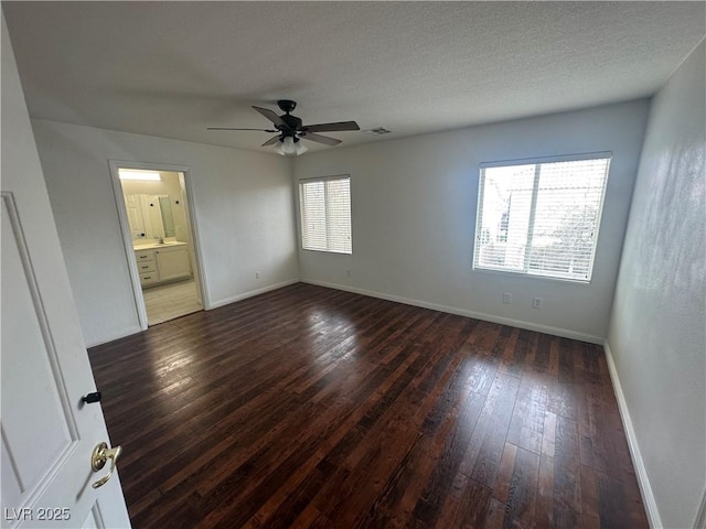 8215 Shell Beach Ct, Las Vegas, NV 89117 - empty room featuring a ceiling fan, dark wood-type flooring, and baseboards