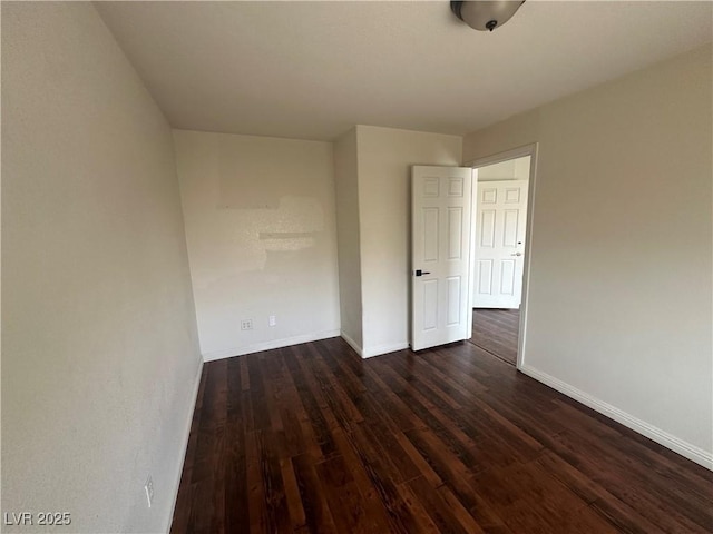 8215 Shell Beach Ct, Las Vegas, NV 89117 - empty room with dark wood-type flooring and baseboards
