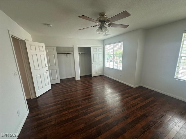 8215 Shell Beach Ct, Las Vegas, NV 89117 - unfurnished bedroom with two closets, dark wood-style floors, and baseboards