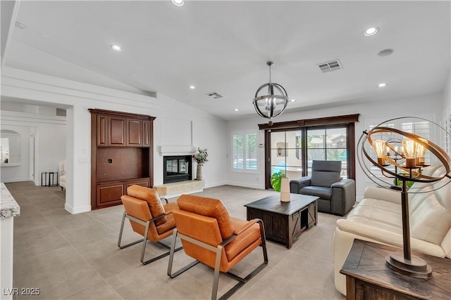 4196 Balmoral Castle Ct, Las Vegas, NV 89141 - living area with a chandelier, lofted ceiling, recessed lighting, a glass covered fireplace, and light tile patterned floors