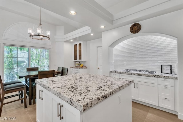 4196 Balmoral Castle Ct, Las Vegas, NV 89141 - kitchen featuring a chandelier, light tile patterned floors, a center island, white gas cooktop, and recessed lighting