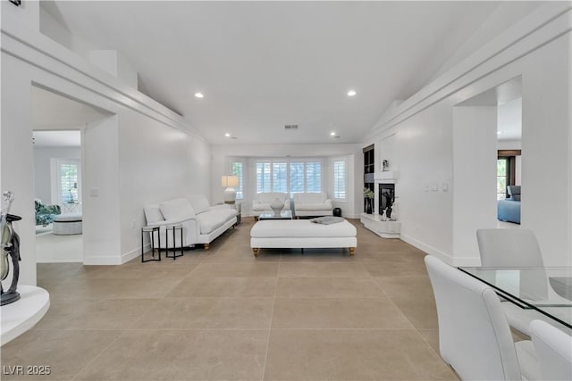 4196 Balmoral Castle Ct, Las Vegas, NV 89141 - living room featuring plenty of natural light, light tile patterned floors, recessed lighting, vaulted ceiling, and baseboards