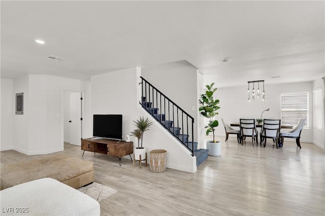 10554 Lilac Tree Ave, Las Vegas, NV 89135 - living area featuring light wood-style floors, stairs, baseboards, and recessed lighting