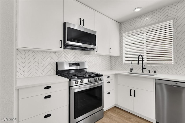 10554 Lilac Tree Ave, Las Vegas, NV 89135 - kitchen featuring stainless steel appliances, a sink, light countertops, and backsplash