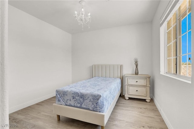 10554 Lilac Tree Ave, Las Vegas, NV 89135 - bedroom featuring wood finished floors, baseboards, and a chandelier