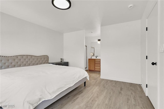 10554 Lilac Tree Ave, Las Vegas, NV 89135 - bedroom featuring light wood-type flooring, ensuite bath, and baseboards