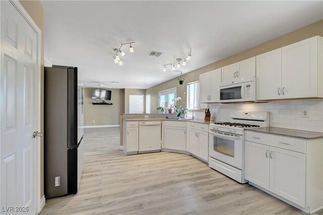 8333 Valley Stream Ave, Las Vegas, NV 89131 - kitchen featuring white appliances, a peninsula, and white cabinetry
