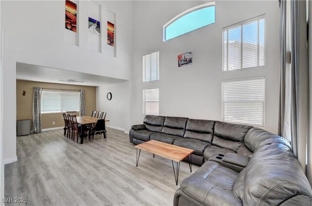 8333 Valley Stream Ave, Las Vegas, NV 89131 - living room featuring a high ceiling, light wood finished floors, and baseboards