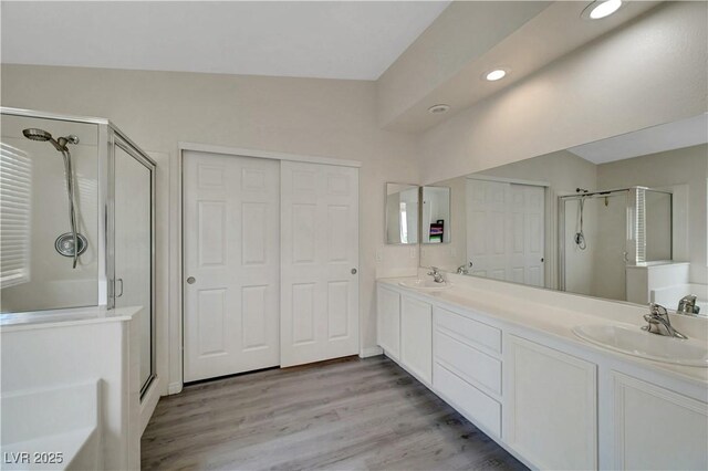8333 Valley Stream Ave, Las Vegas, NV 89131 - bathroom with a shower stall, double vanity, wood finished floors, and recessed lighting
