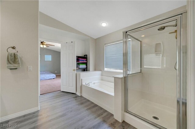 8333 Valley Stream Ave, Las Vegas, NV 89131 - bathroom with vaulted ceiling, a stall shower, a bath, wood finished floors, and a ceiling fan