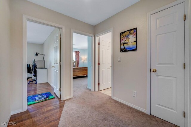 8333 Valley Stream Ave, Las Vegas, NV 89131 - hall featuring baseboards, wood finished floors, and a desk