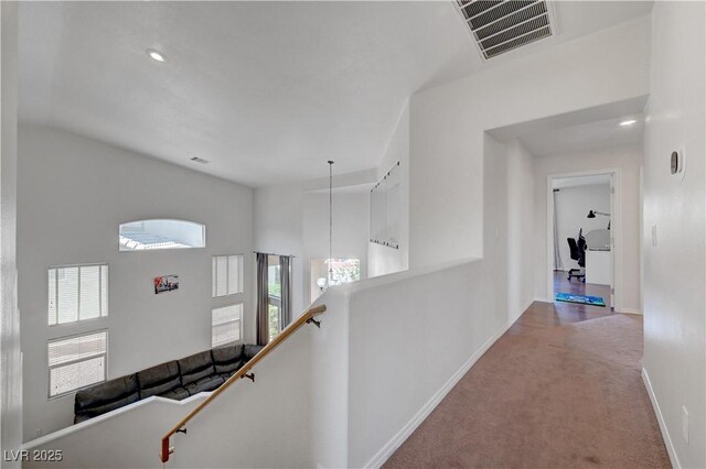 8333 Valley Stream Ave, Las Vegas, NV 89131 - hallway featuring healthy amount of natural light, carpet, an upstairs landing, baseboards, and lofted ceiling