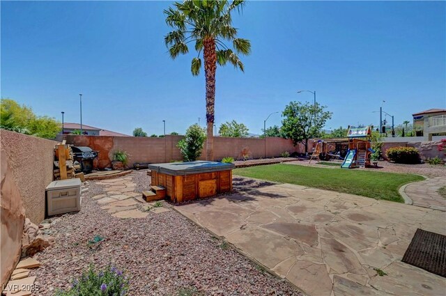 8333 Valley Stream Ave, Las Vegas, NV 89131 - view of patio / terrace with a hot tub and a playground