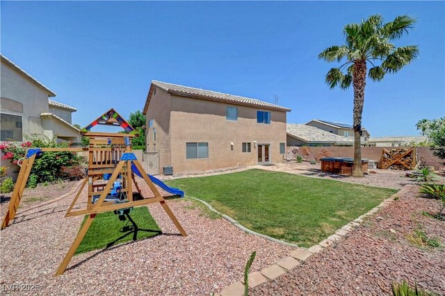 8333 Valley Stream Ave, Las Vegas, NV 89131 - back of property with a hot tub, a playground, stucco siding, and a patio area