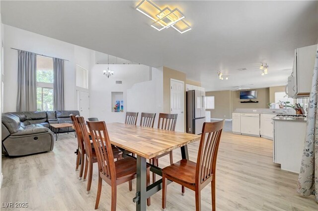 8333 Valley Stream Ave, Las Vegas, NV 89131 - dining space featuring light wood-type flooring, plenty of natural light, and a chandelier
