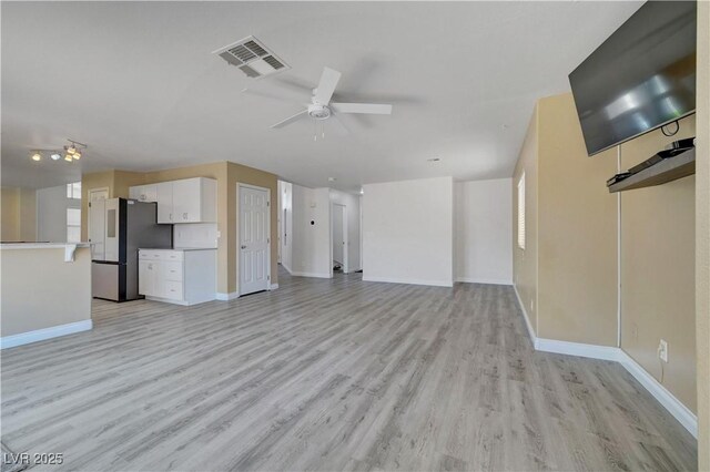 8333 Valley Stream Ave, Las Vegas, NV 89131 - unfurnished living room with light wood finished floors, a ceiling fan, and baseboards