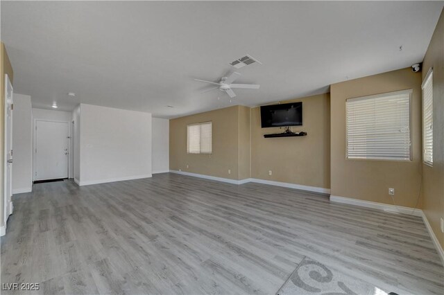 8333 Valley Stream Ave, Las Vegas, NV 89131 - unfurnished living room featuring a ceiling fan, light wood finished floors, and baseboards