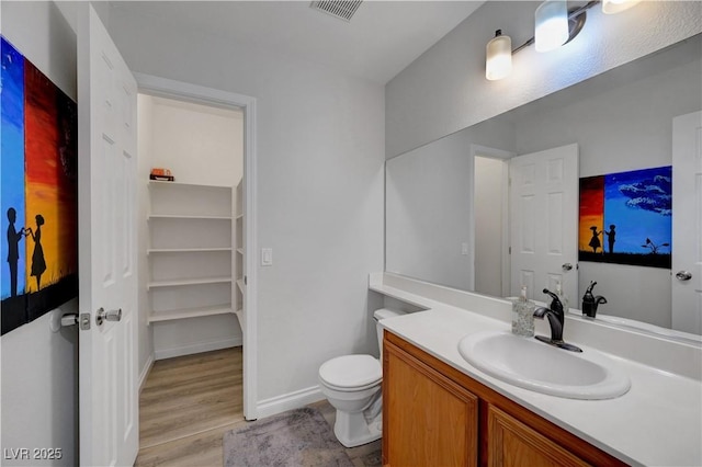 8333 Valley Stream Ave, Las Vegas, NV 89131 - bathroom with wood finished floors, toilet, vanity, and baseboards