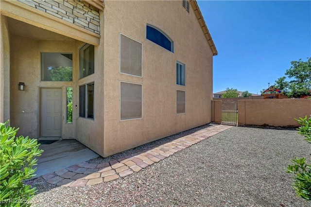 8333 Valley Stream Ave, Las Vegas, NV 89131 - view of property exterior with stucco siding and a gate