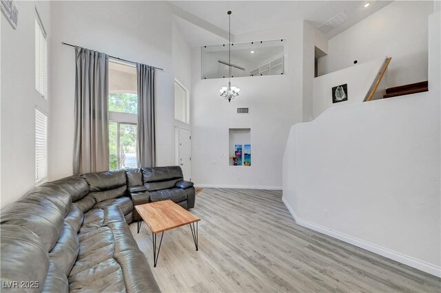 8333 Valley Stream Ave, Las Vegas, NV 89131 - living area with a high ceiling, wood finished floors, a chandelier, baseboards, and recessed lighting