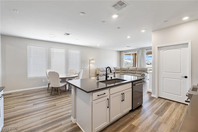 171 Palm Fox Ct, Henderson, NV 89011 - kitchen with a sink, stainless steel dishwasher, dark countertops, light wood-type flooring, and open floor plan
