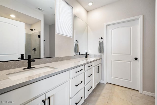 171 Palm Fox Ct, Henderson, NV 89011 - bathroom with double vanity, a stall shower, tile patterned floors, and baseboards