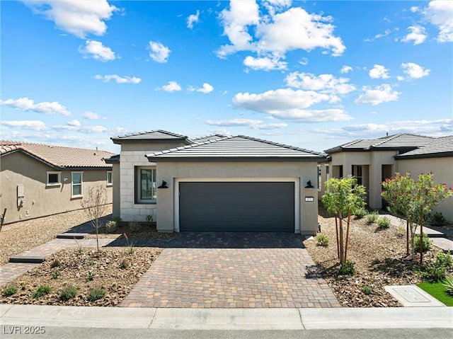 171 Palm Fox Ct, Henderson, NV 89011 - prairie-style house with an attached garage, stucco siding, decorative driveway, and a tiled roof