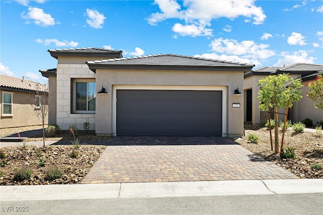 171 Palm Fox Ct, Henderson, NV 89011 - prairie-style home featuring decorative driveway, a garage, stucco siding, and a tile roof