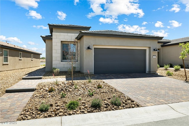 171 Palm Fox Ct, Henderson, NV 89011 - prairie-style house with a garage, decorative driveway, stucco siding, and a tile roof