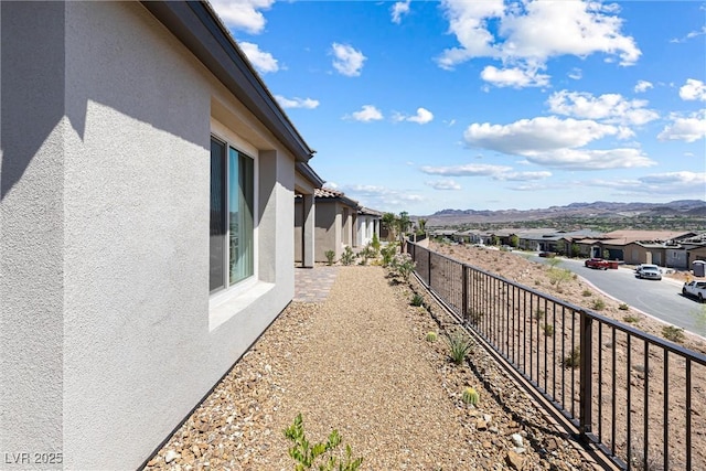 171 Palm Fox Ct, Henderson, NV 89011 - view of side of home featuring stucco siding, a residential view, and a mountain view