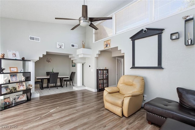 45 N Lamb Blvd, Las Vegas, NV 89110 - living area with high vaulted ceiling, ceiling fan, wood finished floors, and baseboards