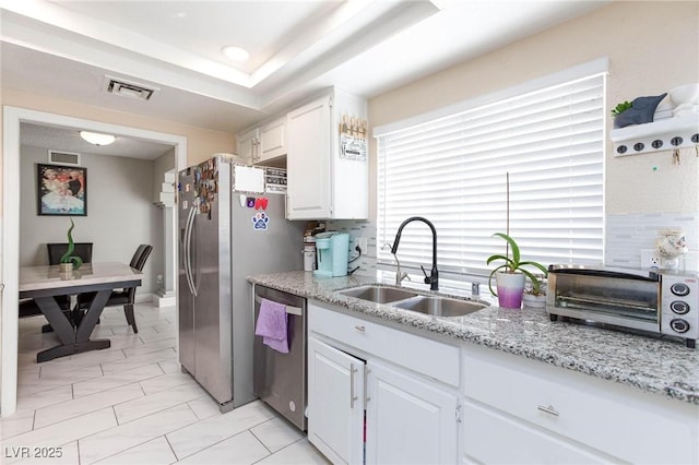 45 N Lamb Blvd, Las Vegas, NV 89110 - kitchen featuring appliances with stainless steel finishes, a sink, white cabinets, decorative backsplash, and recessed lighting