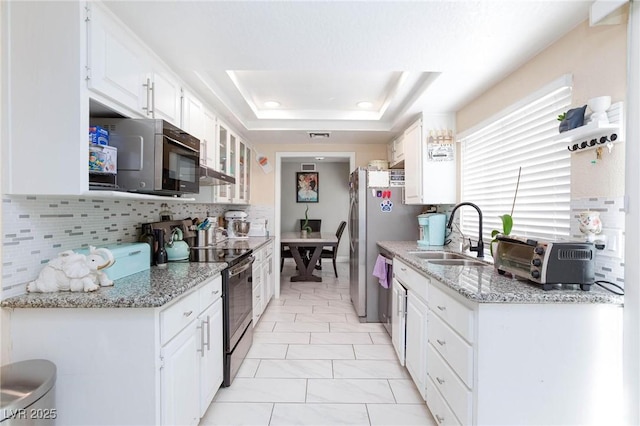 45 N Lamb Blvd, Las Vegas, NV 89110 - kitchen featuring a sink, appliances with stainless steel finishes, white cabinetry, and backsplash